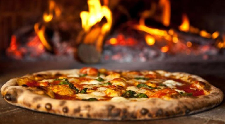 Margherita in front of the Woodstone oven